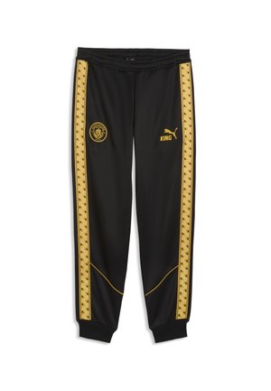 Czarne spodnie sportowe ze złotymi paskami po bokach, logo Manchester City na lewym udzie, logo Puma i tekst "KING" na prawym udzie, elastyczny pas i ściągacze.