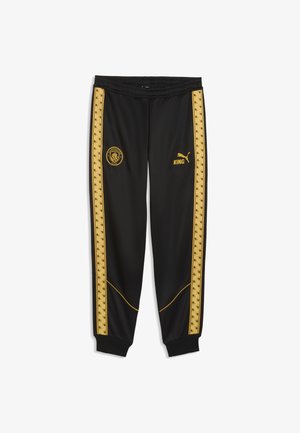 Schwarze Sporthose mit goldenen Seitenstreifen, Manchester City-Logo am linken Oberschenkel, Puma-Logo und "KING" Schriftzug am rechten Oberschenkel, elastischer Bund und Bündchen.
