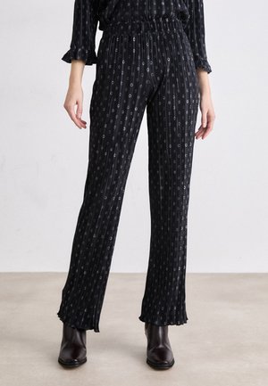 Black, pinstriped pants with a relaxed fit. Features elastic waistband, frayed hems, and subtle silver detailing throughout. Smooth fabric texture.