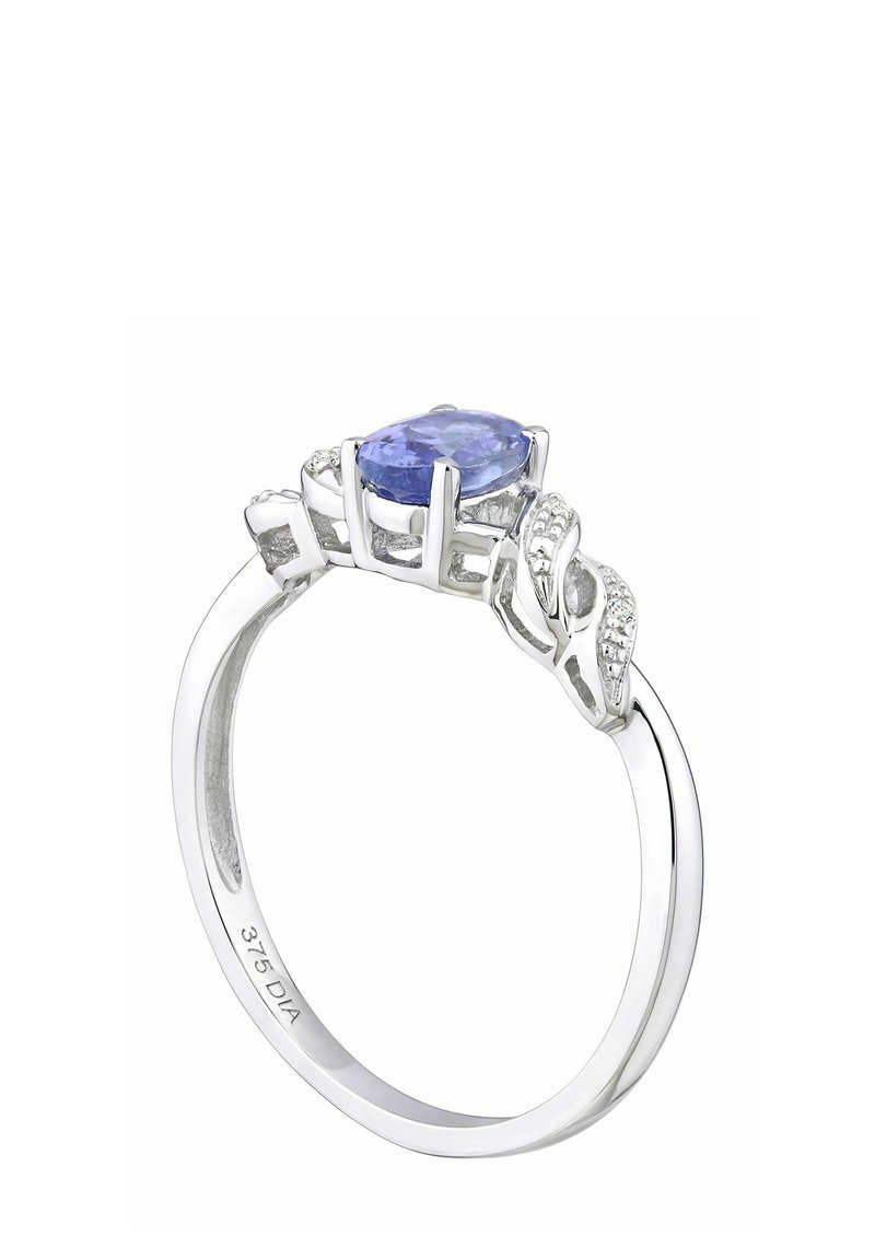 Hopea rengas, jossa on ovaali tanzaniittikeskuskivivä, ympärillä timanttiaksentteja; monimutkainen lehtimäinen muotoilu rengaspinnalla.