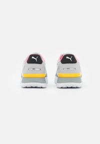 Pair of Puma sneakers shown from the back with gray, white, pink, teal, and yellow accents on a white background.