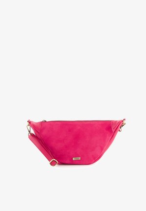 Pink suede crossbody bag with a curved design, zipper closure, and adjustable strap. Features a metal logo accent and smooth texture.