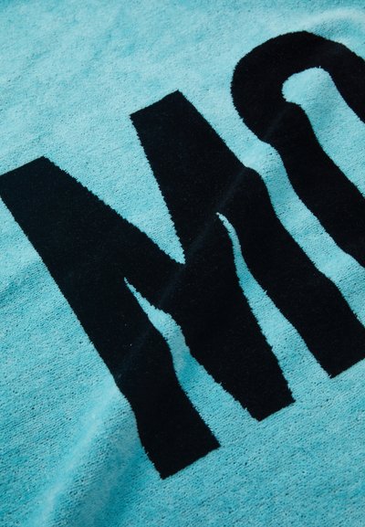 Turquoise fabric featuring bold, black lettering. Material appears soft with a textured, plush surface and alternating patterns.