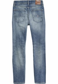 Denimjeans i blek ljusblå färg med rak benben. Har två bakfickor och en läderlogotyp på midjan. Sliten struktur synlig.