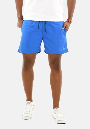 Blaue Badehose mit elastischem Bund und schwarzem Kordelzug. Verfügt über seitliche Taschen und ein kleines grünes Logo am linken Bein.