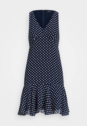 Marineblaues ärmelloses Kleid mit weißen Punkten, V-Ausschnitt, tailliert und ausgestelltem Saum.