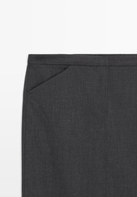 Dark gray fabric close-up showing the upper part of pants with a waistband and a slanted front pocket.