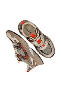 Beige en bruine sportschoenen met een bovenwerk van gaas, textuuraccenten in het rood en een rubberen zool. Voorzien van dunne veters en een logo aan de binnenkant. Maat 38.