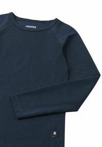 Navy thermal long-sleeve shirt with a round neck and tag featuring a small logo. Made of smooth, stretchy fabric with flatlock seams.