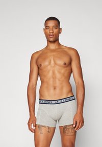 Gray boxer briefs with a dark blue waistband featuring "JACK & JONES" branding. The fabric is smooth and stretchy.