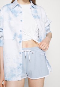 Ellesse Teplákové kalhoty - light blue