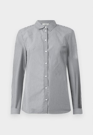 Striped button-up shirt in black and white cotton fabric. Features a classic collar and long sleeves with button cuffs.