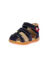 Navy and beige sandal with crisscross straps, Velcro closures, and orange accent. Textured rubber sole. Suitable for children.