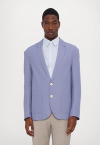 Light purple blazer with two front pockets, single-button closure, and notched lapels. Worn over a light blue collared shirt.
