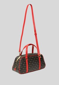 Borsa a mano in tessuto nero con motivo ripetuto, spallacci rossi e finiture dorate. Presenta una chiusura superiore con zip e doppi manici.