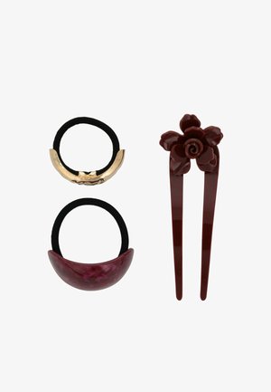 Set di tre accessori per capelli: un elastico per capelli oro e nero, un elastico a mezzaluna color maroon e una mollettina maroon con un design a rosa.