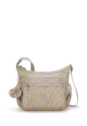 Sac bandoulière beige texturé avec une poche zippée à l'avant, un compartiment latéral zippé et un charm en fourrure attaché à la sangle.