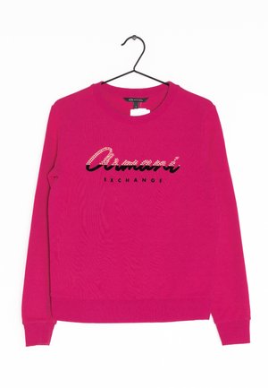 Felpa fucsia con maniche lunghe e collo a giro. Presenta il logo nero "Armani Exchange" con dettagli in strass sul petto.
