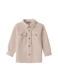 Chaqueta de botonadura de pana beige con mangas largas, dos bolsillos en el pecho con solapa y botones de madera sobre un fondo blanco.