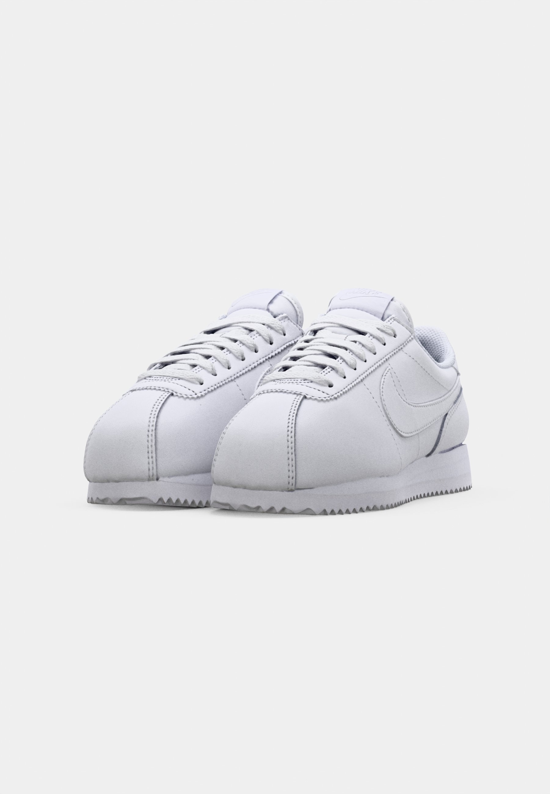 grey and white nike cortez