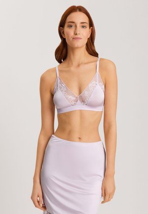 Light lavender bralette with lace overlay, adjustable thin straps, and smooth fabric. Paired with a matching satin skirt.