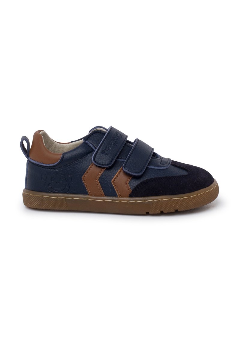 Navy blue sneaker with brown accents, featuring velcro straps, a textured leather upper, rubber sole, and a loop tab at the back.