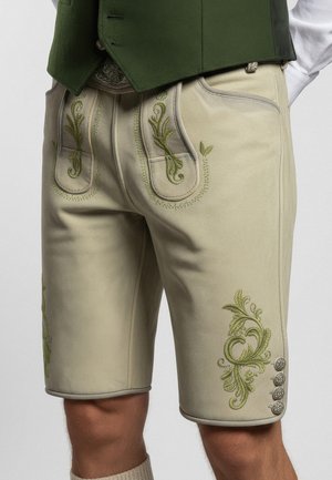 Läderbyxor i ljusbeige med grön blomsterbroderi, sidofickor och silverfärgade knappar. Slät textur och skräddarsydd passform.