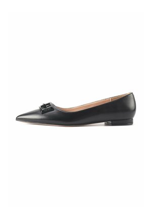 Black leather ballet flats with a pointed toe, featuring a decorative bow detail on the vamp and a low, square heel. Smooth texture.