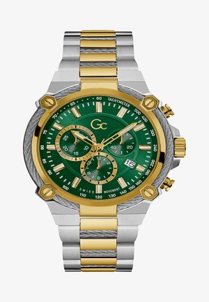Roheline kroonograafia kell kuld- ja hõbetoonilise roostevabast terasest rihmaga, tekstureeritud äärisega, kuupäevanäidikuga ja tahhümeetri skaalaga dialil.