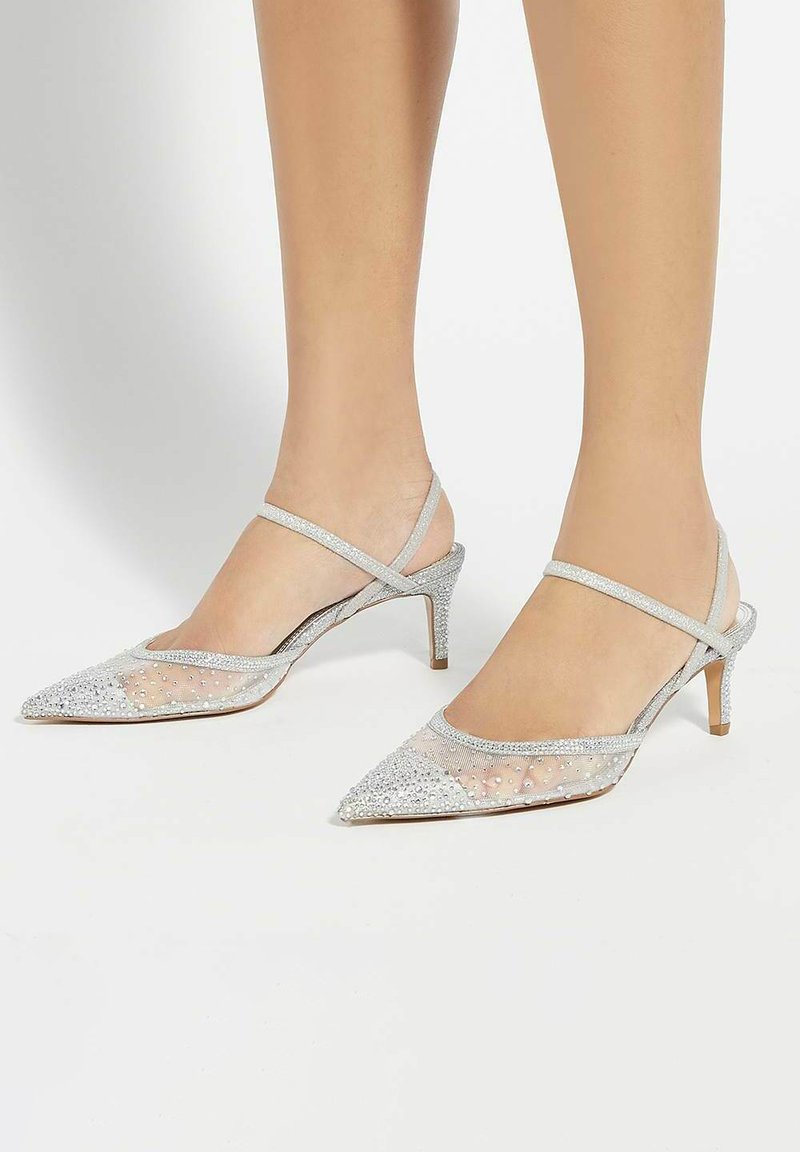 Silver slingback heels with a pointed toe and small heel, featuring a mesh design embellished with sparkling rhinestones.