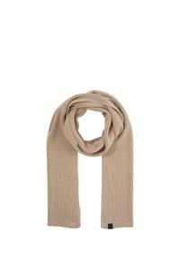 Écharpe beige côtelée en matériau doux, avec un design simple, comportant une étiquette à une extrémité et drapée en boucle.