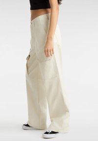 Beige cargobroek met een losse pasvorm, voorzien van zijzakken en een rechte tailleband. Gemaakt van katoenstof, met een soepele textuur.