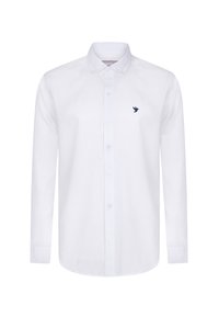 Camisa blanca de manga larga en una tela suave, con un frente abotonado y un pequeño logo de un pájaro en color marino en el lado izquierdo del pecho.