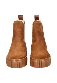 Braune Wildleder-Stiefeletten mit strukturierter Oberfläche, gerippter Gummisohle und seitlichen elastischen Einsätzen. Oben mit Schlaufe für einfaches Anziehen.