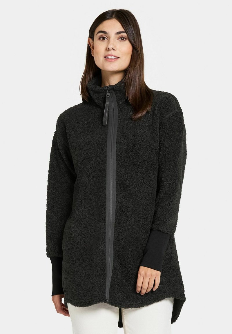 Schwarze Fleecejacke mit hohem Kragen und einem Reißverschluss vorne. Verfügt über lange Ärmel mit schwarzen Bündchen und einer weichen, strukturierten Oberfläche.
