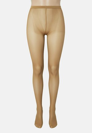 Collants transparents couleur peau exposés sur un mannequin avec une ceinture visible et une zone d'orteils renforcée, présentés sur un fond uni.