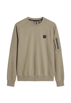 Beige, lange mouw, crewneck sweatshirt met een klein zwart patch op de borst en een ritsvak aan de linkerarm.