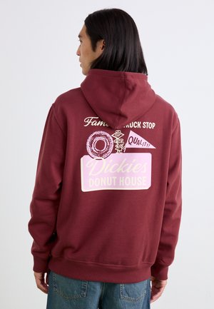 Maroon hoodie featuring graphic prints on the back, including "Dickies Donut House" and a donut icon, with ribbed cuffs and hem.