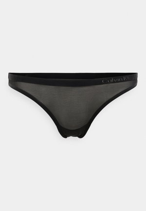 Černé průhledné spodní prádlo se silným černým páskem, hladkým povrchem a nenápadně přízdobou logem Calvin Klein po straně.