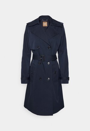 Navy blue trench coat made of smooth fabric, featuring a belted waist, double-breasted front, wide collar, and cuff straps.