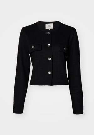 Black cropped jacket with long sleeves, textured fabric, featuring a round neck, two front pockets, and metallic button detailing.