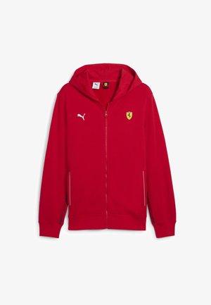 Sarkanais rāvējslēdzēja džemperis, kas izgatavots no kokvilnas maisījuma. Iespējas: ar kapuci, priekšējām kabatām, Puma logo uz krūšu daļas un Ferrari emblem ar kreisajā pusē.