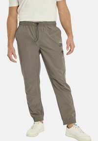 Men's lightweight, olive-green pants with elastic waistband, zippered pocket, and elastic cuffs; smooth fabric with reinforced knee panels.