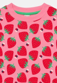 Pink sweatshirt featuring a repeated strawberry pattern, with green leaves and small ladybug accents. Soft fabric and ribbed neckline.