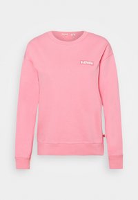 Sudadera rosa hecha de tejido suave, con cuello redondo, mangas largas y un pequeño logo de Levi's en el pecho. Presenta puños y dobladillo acanalados.