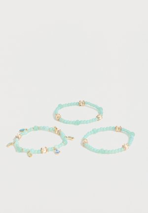 Three light blue beaded stretch bracelets, two with gold and crystal spacers, one with additional blue and yellow gem charms.