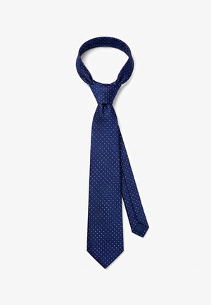 Navy blue silk tie with white polka dots, partially tied in a Windsor knot, displayed on a white background.