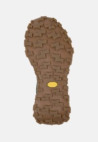 Rubber boot sole with deep lugs for traction. Brown color with a textured surface. Features a yellow Vibram logo and the size 42 indication.