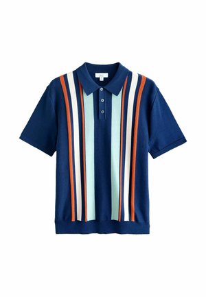 Tamsiai mėlynas polo marškinėlis trumpomis rankovėmis, puošiamas vertikaliomis oranžinėmis, šviesiai mėlynomis ir baltomis juostelėmis. Baigtas apykakle ir trimis mygtukais.