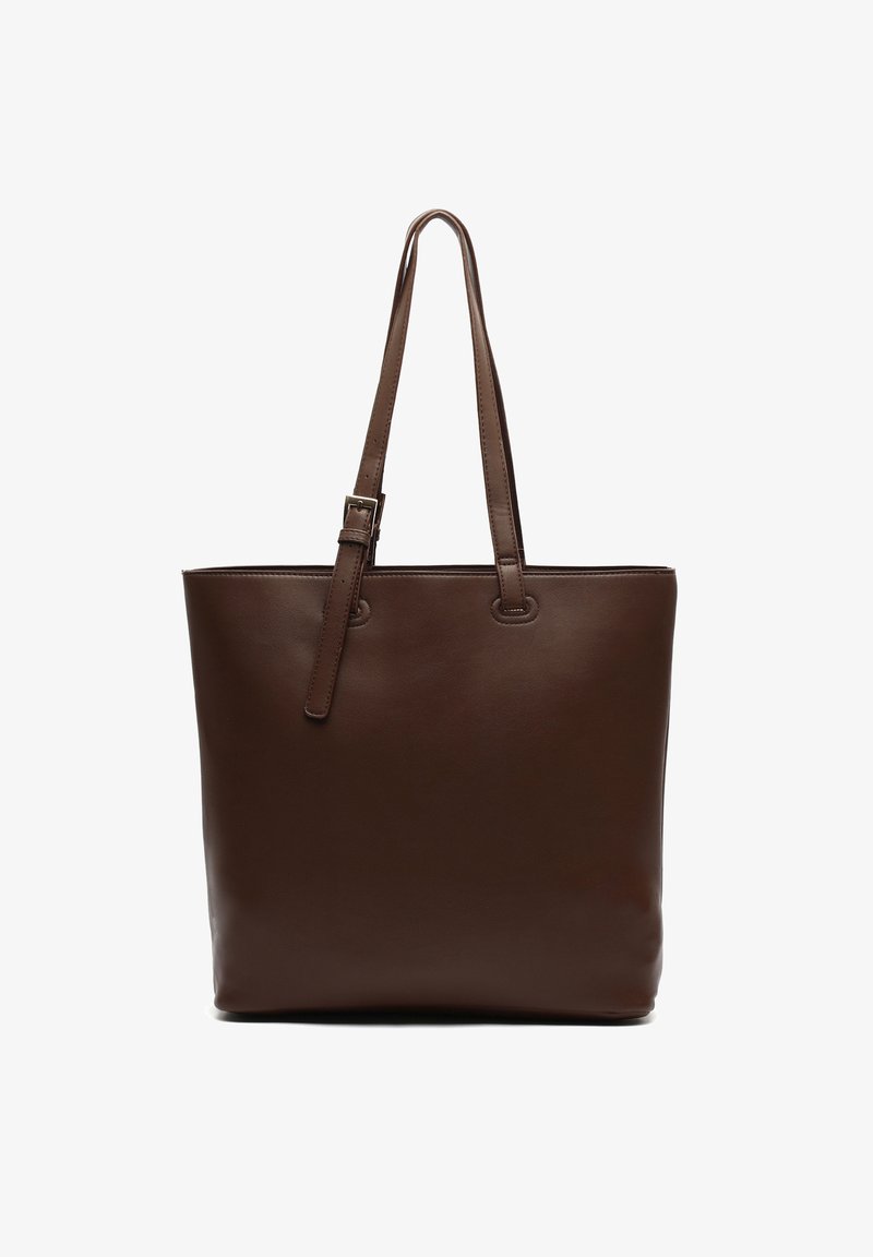 Brown leather tote bag with two long handles, smooth texture, rectangular shape, and reinforced stitching on seams. No visible hardware.